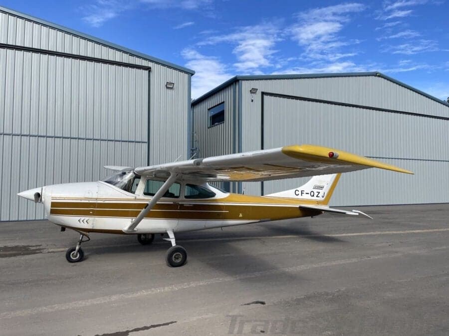 Cessna 182 Skylane parked in front of a hangar.