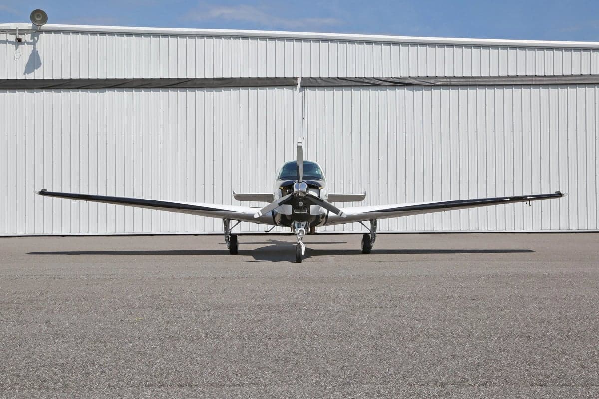 Front view of a Beechcraft Bonanza aircraft on the tarmac.
