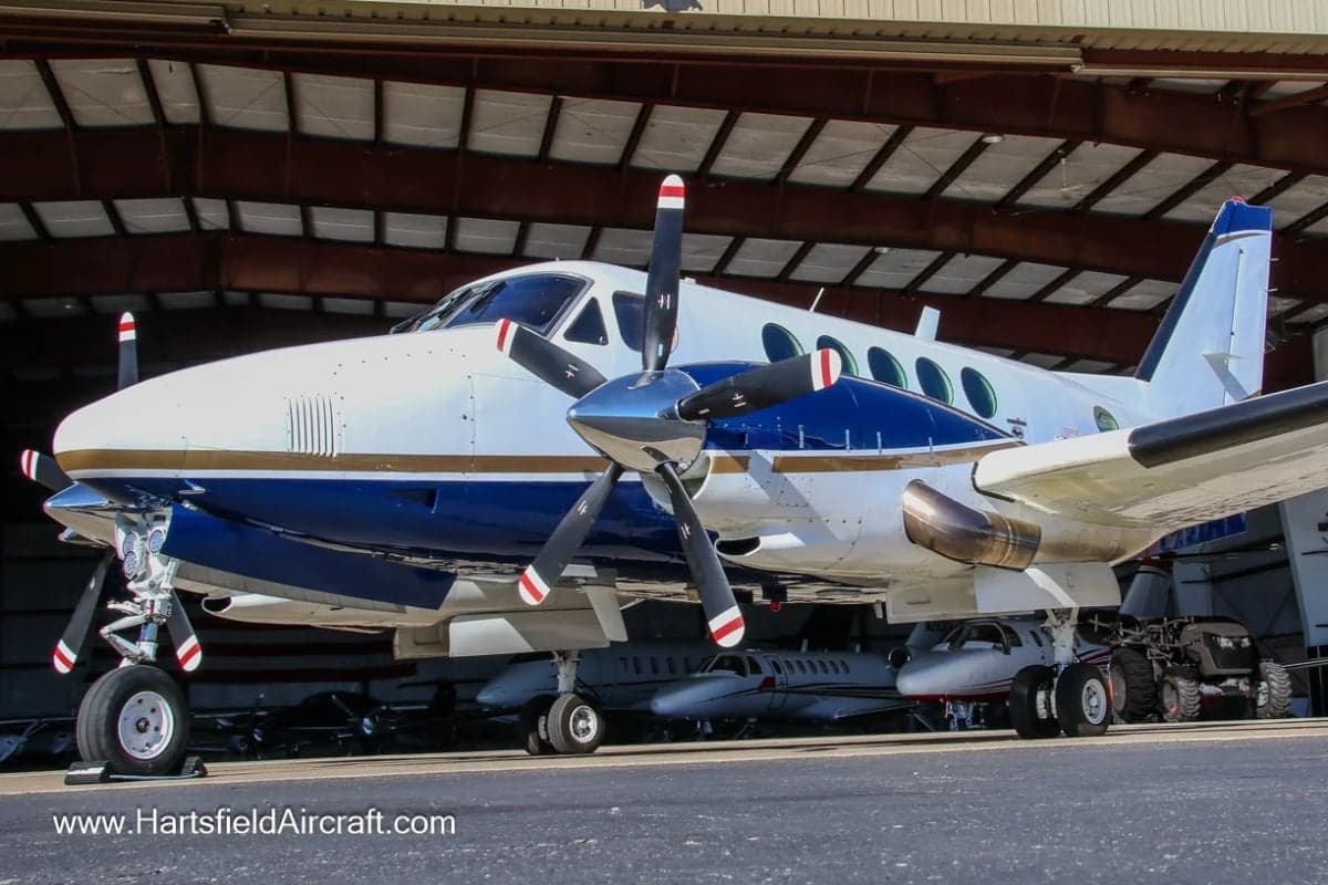 King Air aircraft parked in front of a hangar.
