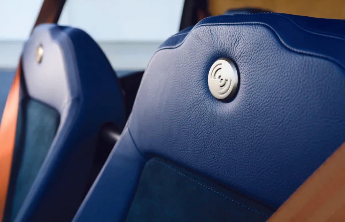 Close-up of blue leather seats in the cabin of a helicopter.