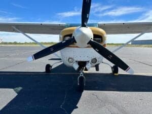 A close-up of the front of a Cessna 182RG on the tarmac.
