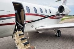 Side view of a Cessna Citation CJ3+ with red and black stripes.