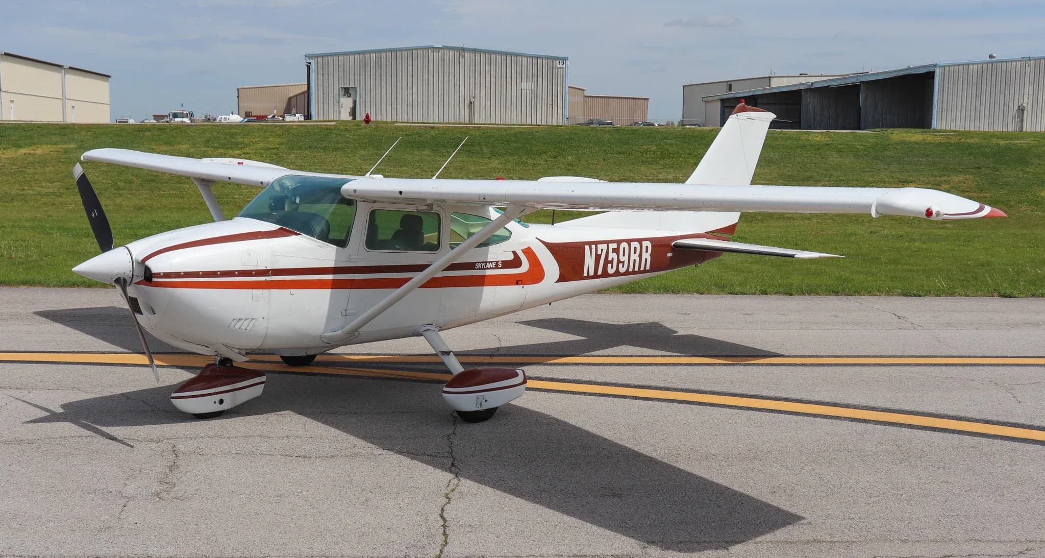 A three-quarter view of the Cessna Skylane S (N759RR) parked on an asphalt ramp.