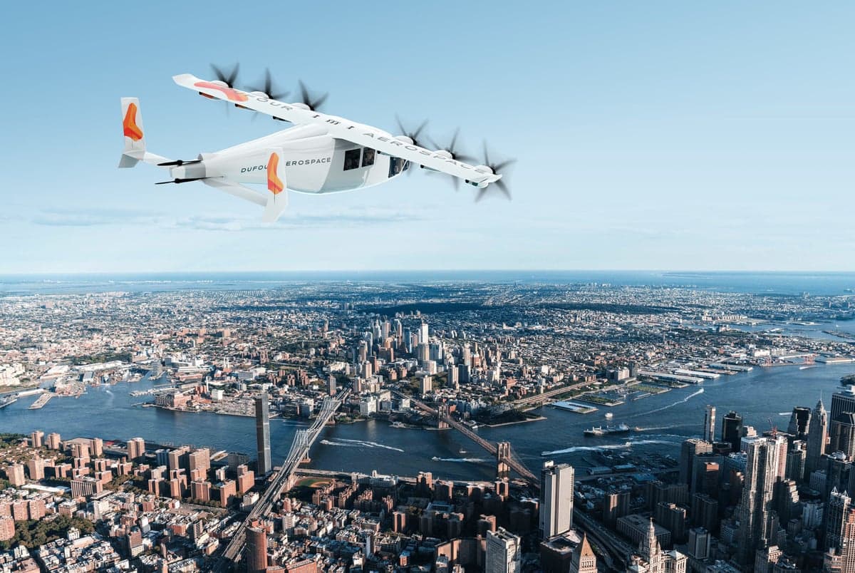 A Dufour Aerospace aircraft flying over a city.
