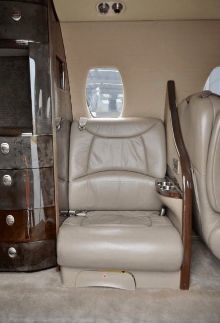 Close up of a leather seat and wood trim in the cabin.