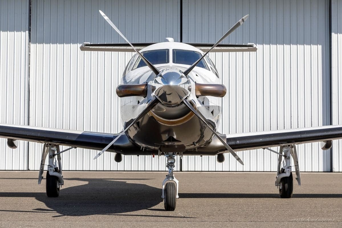 Front view of the Pilatus PC-12 aircraft showing the propeller and landing gear.