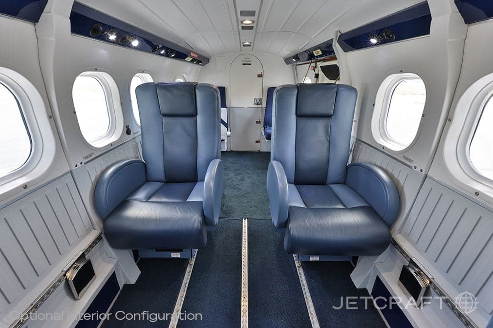 View of the aircraft cabin with blue leather seats.