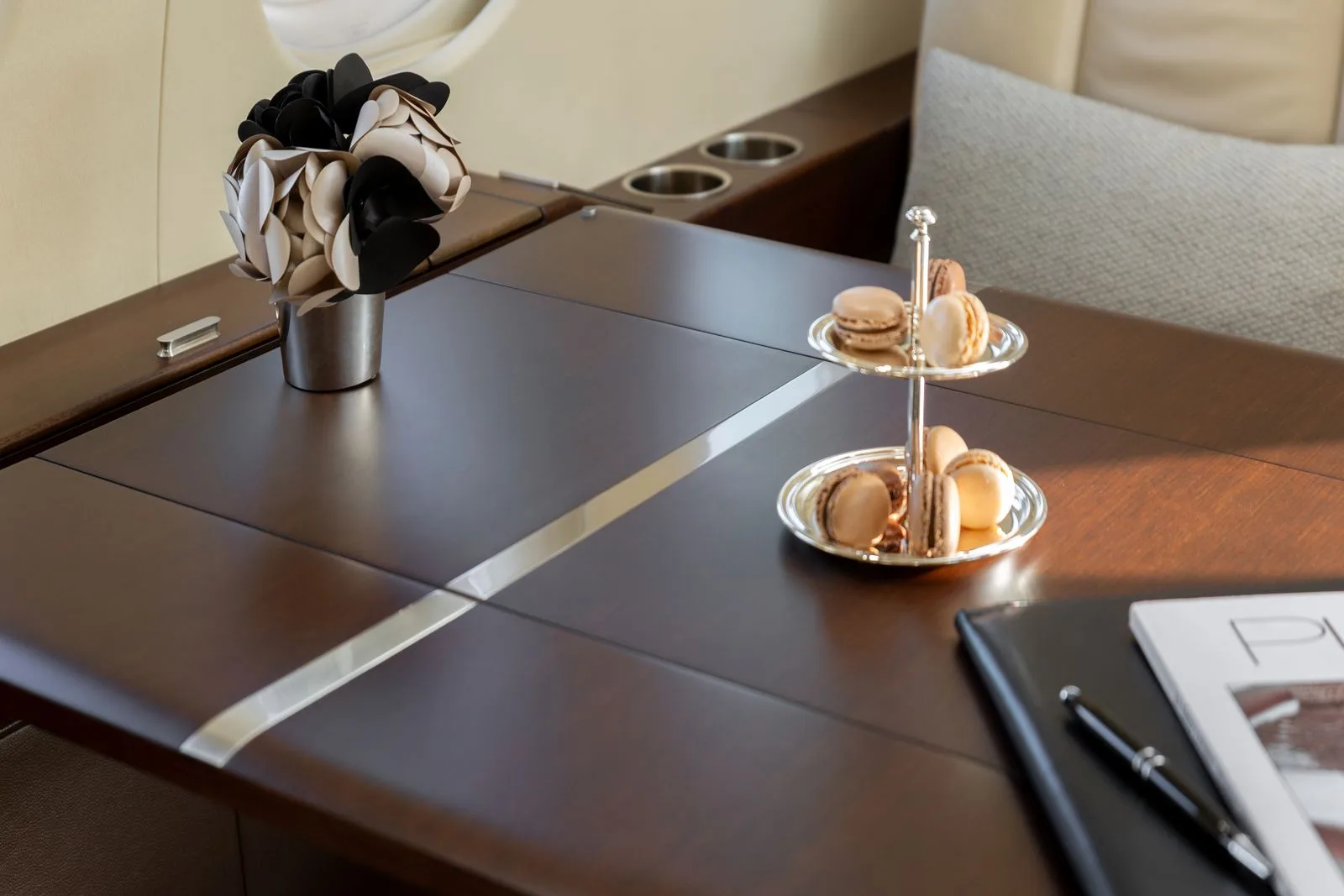 A close up of a table with macarons in a Falcon jet.