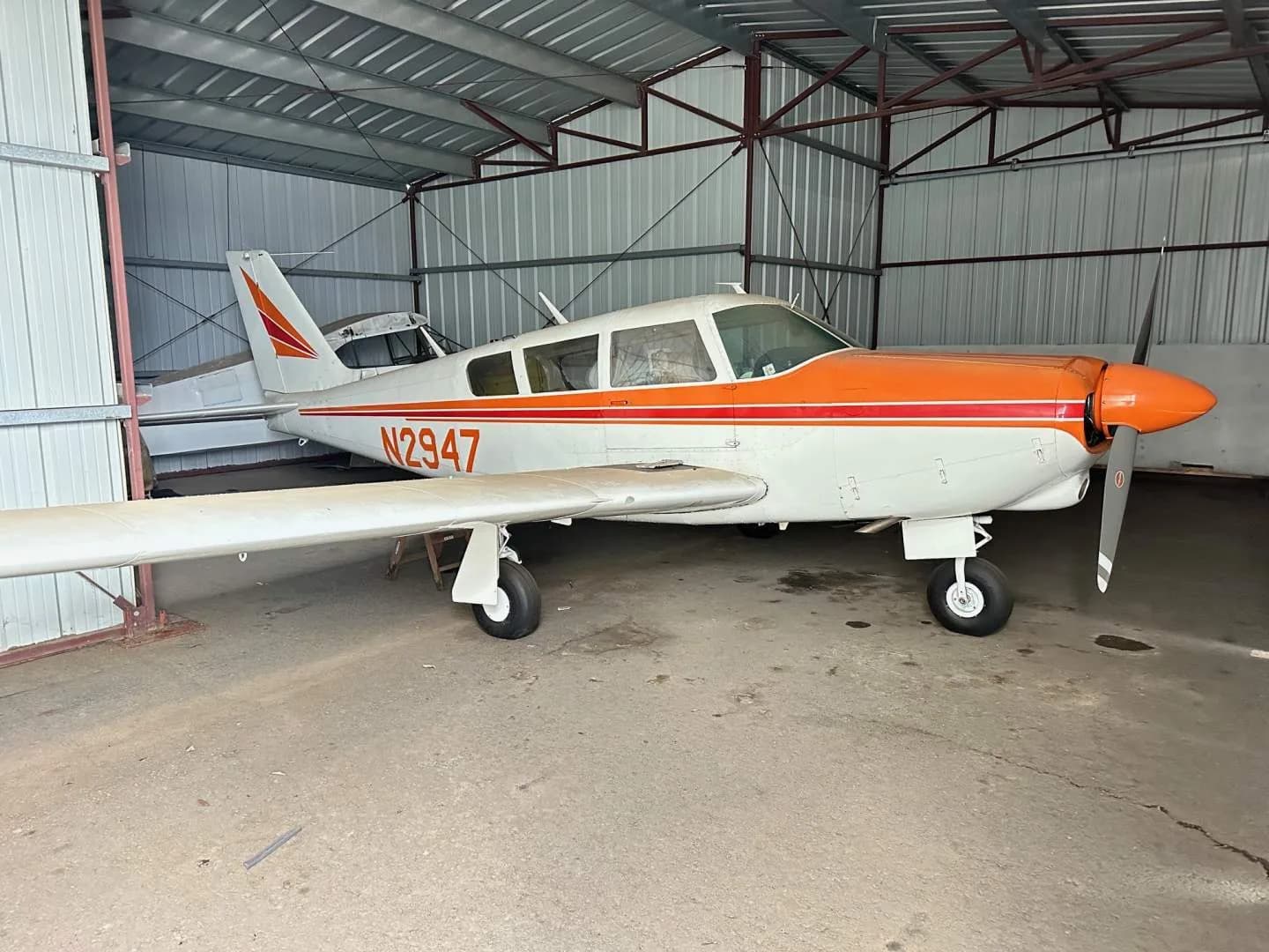 Side view of the N2947 aircraft parked inside a hangar.