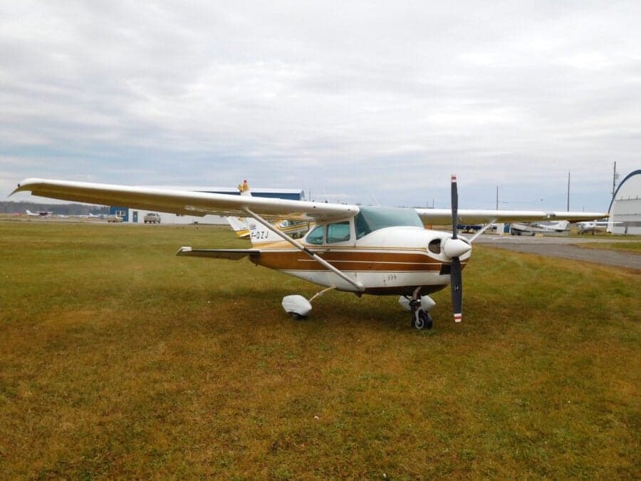 Cessna 182 Skylane parked on a grassy field.
