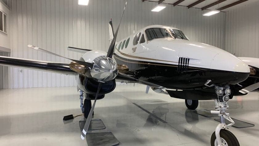 Side view of the aircraft, showing the propeller and paint scheme.