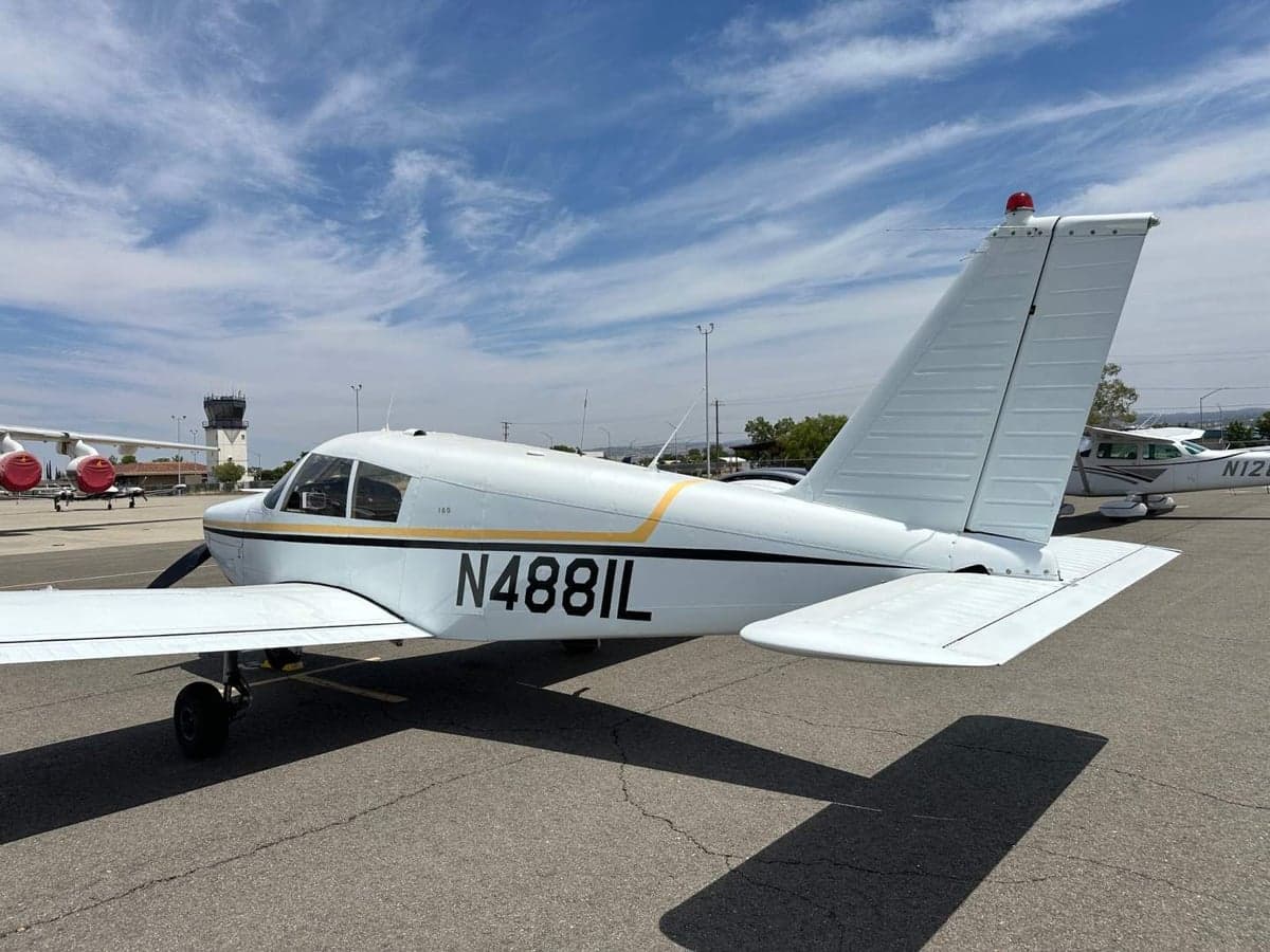 A Piper PA-28-140 Cherokee with tail number N4881L parked on the tarmac.