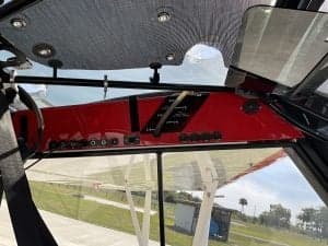 The interior of the aircraft features a red instrument panel and a gray ceiling.
