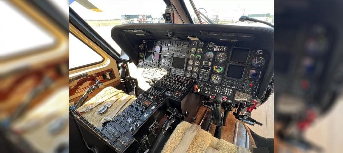 The helicopter's cockpit has a full instrument panel and sheepskin seat covers.