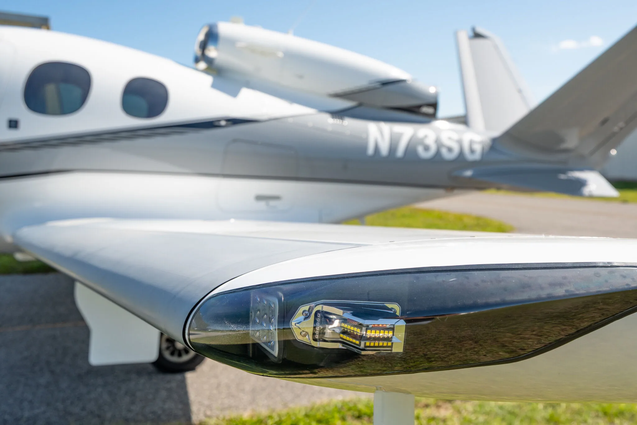 Close-up of the wingtip light and the N73SG tail number on the Cirrus Vision Jet.
