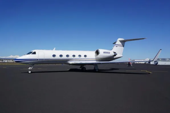 Gulfstream jet with blue and white paint scheme on the tarmac.
