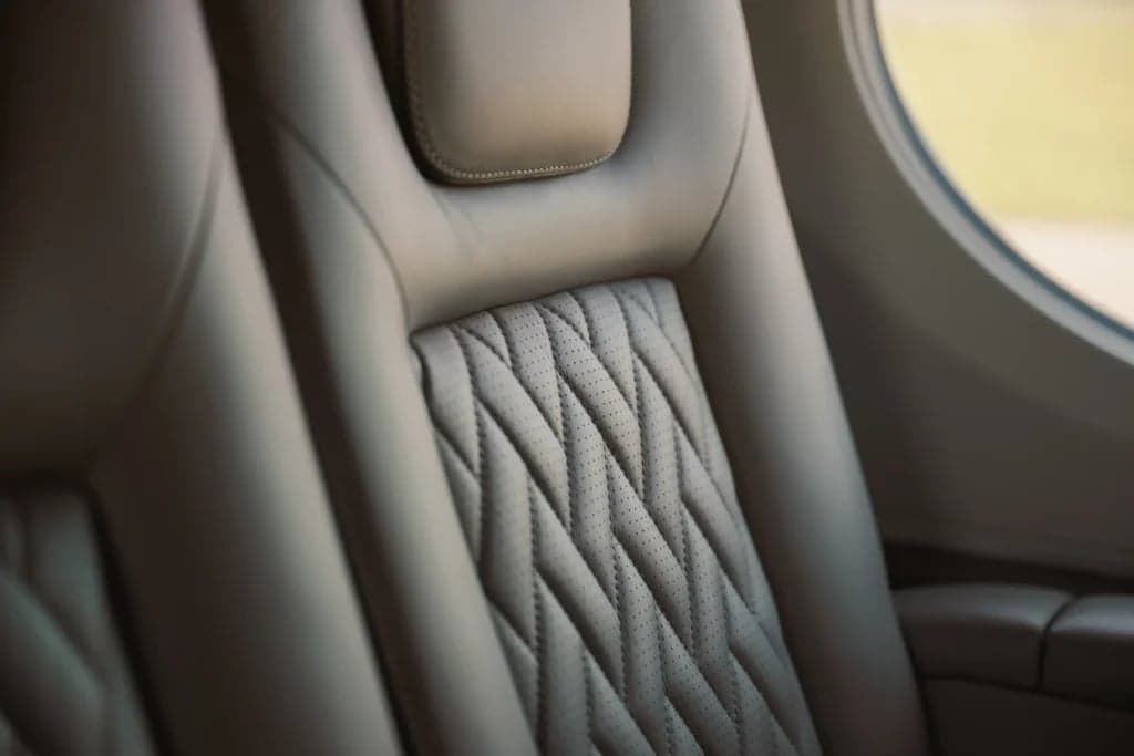 Close-up of the leather seats inside the aircraft cabin.