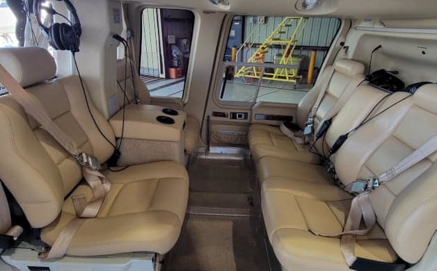 View of the helicopter's interior with tan leather seats.