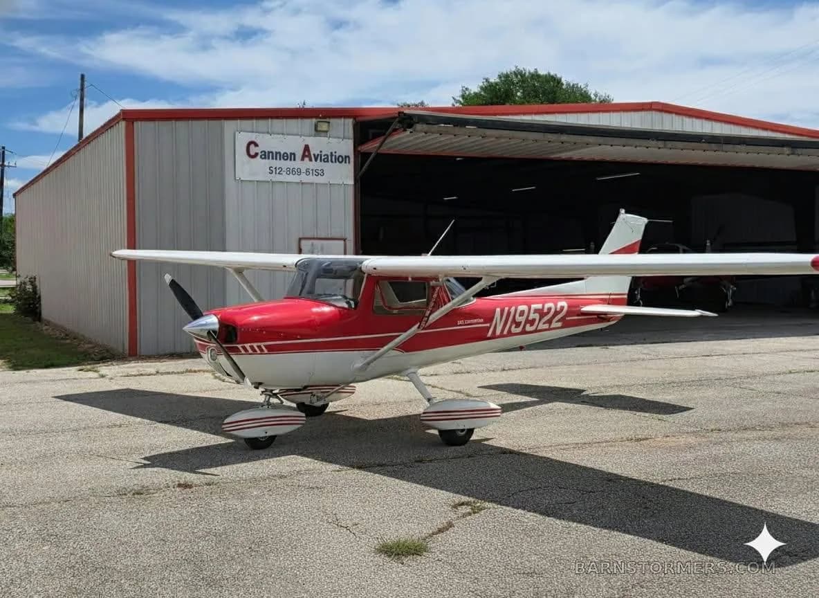 A red and white Cessna 172, registration N19522, parked on an asphalt ramp in front of a hangar with 'Cannen Aviation' on it.