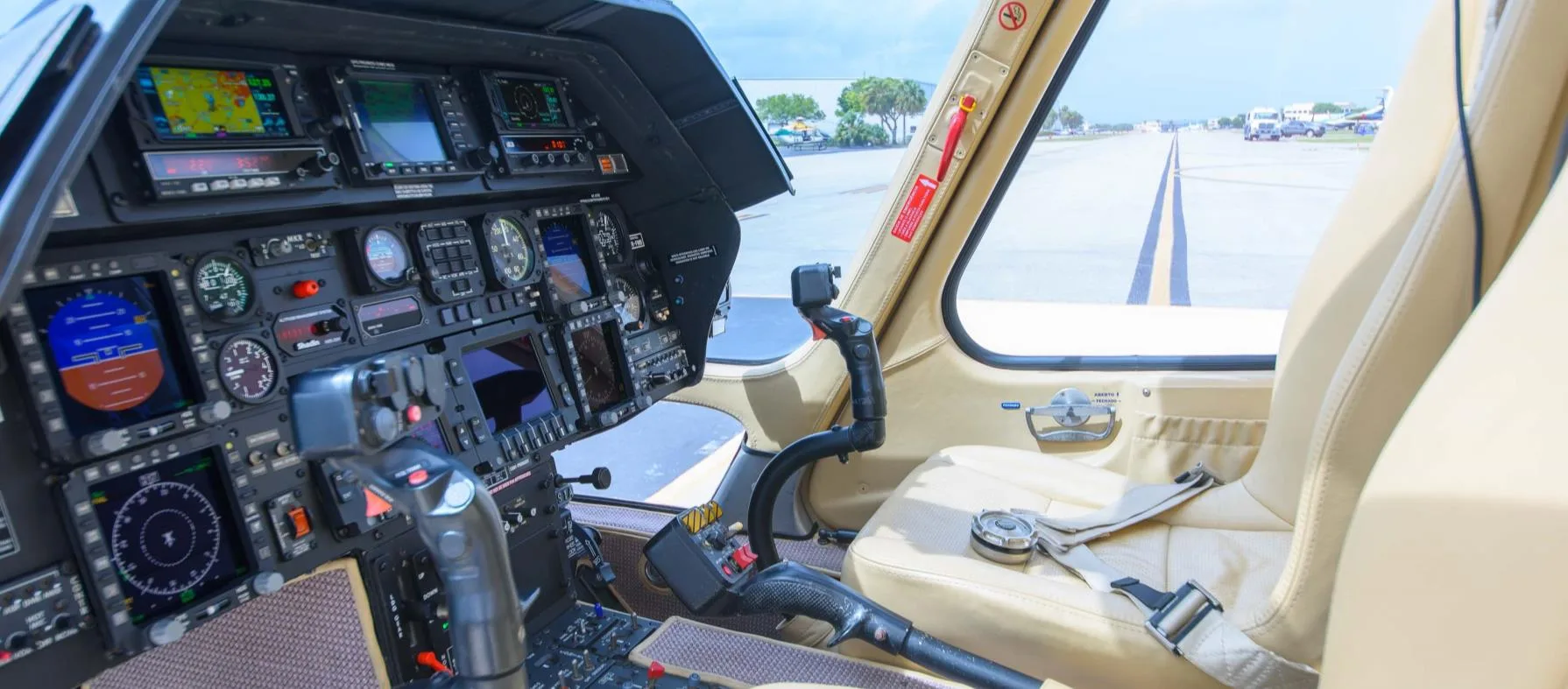 View of the helicopter cockpit with instrument panel and seats.