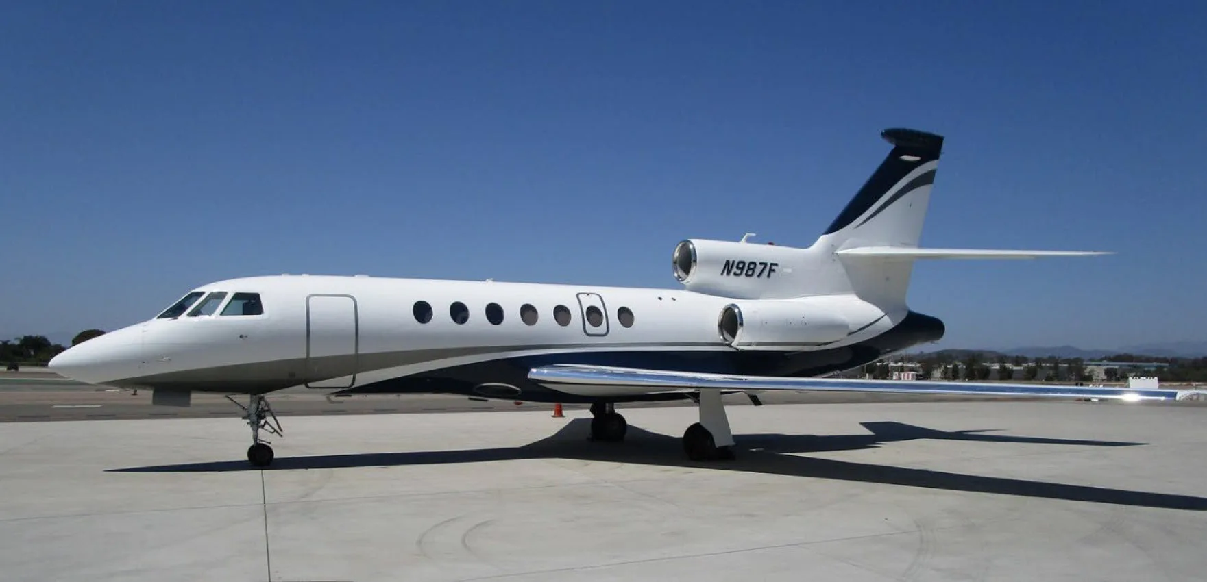 Side view of the N987F aircraft on the tarmac.