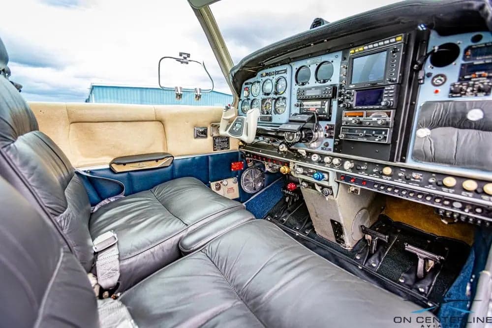 View of the cockpit with gray leather seats and instrument panel.