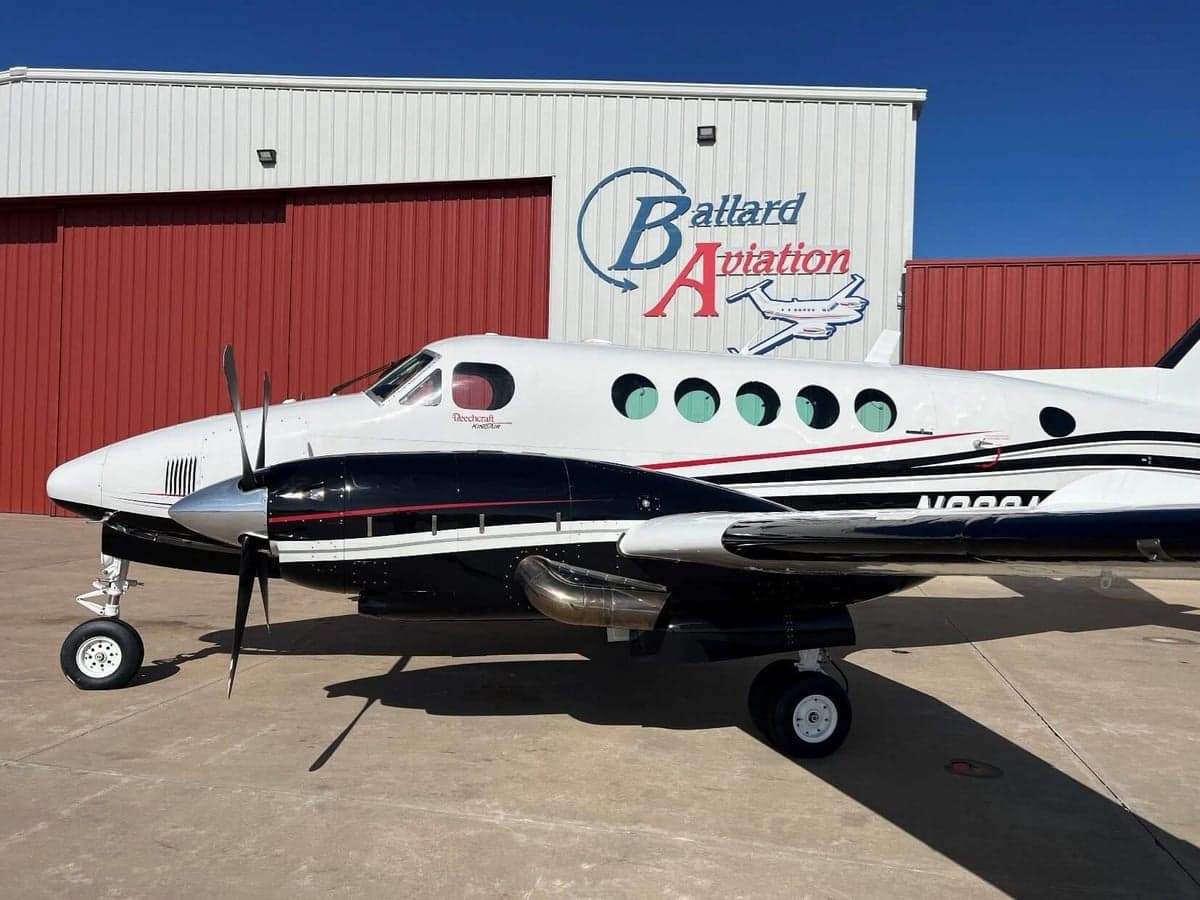 Full side view of a Beechcraft King Air with black and white paint scheme.