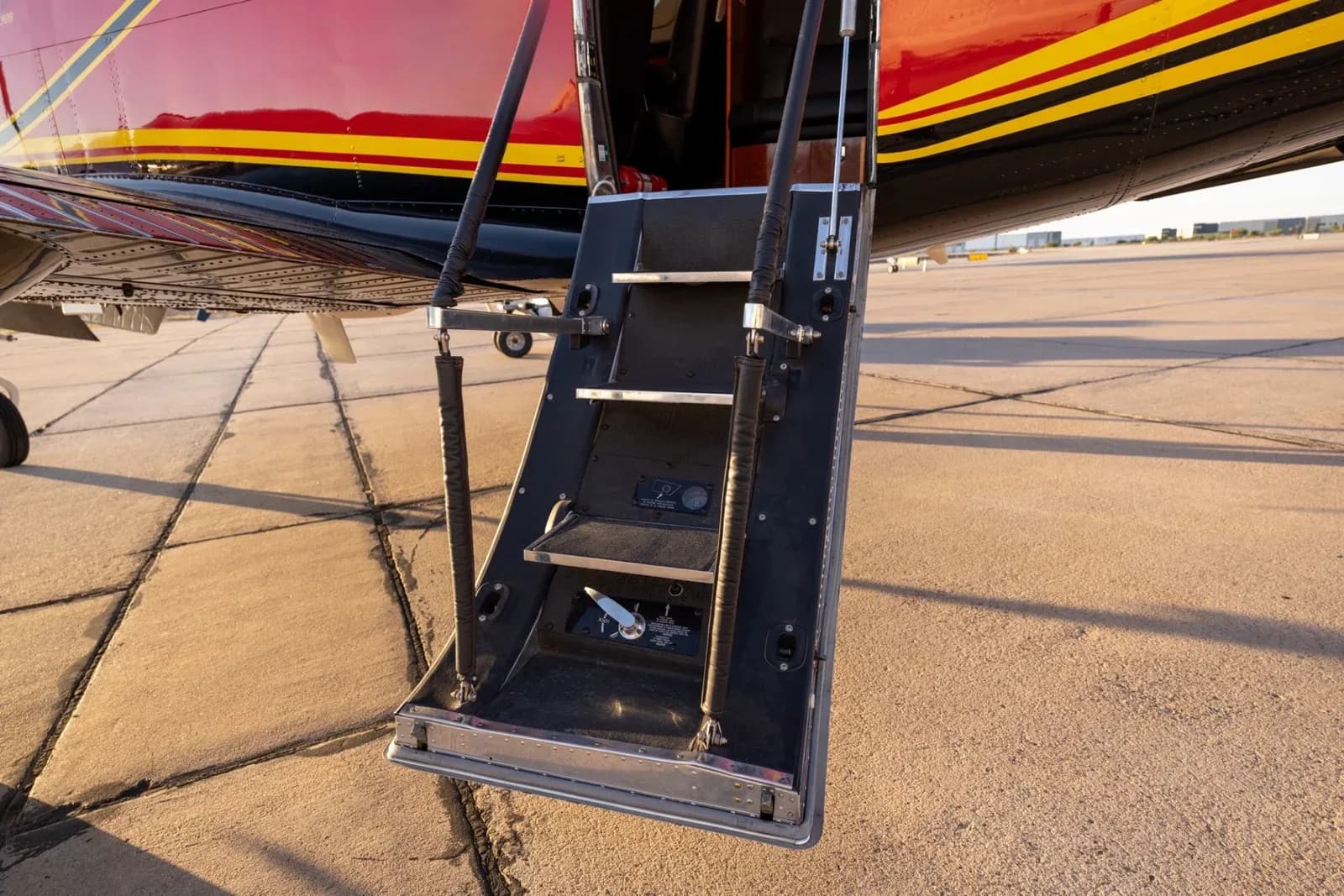 The extended airstair door of the King Air C90B, showing three steps.