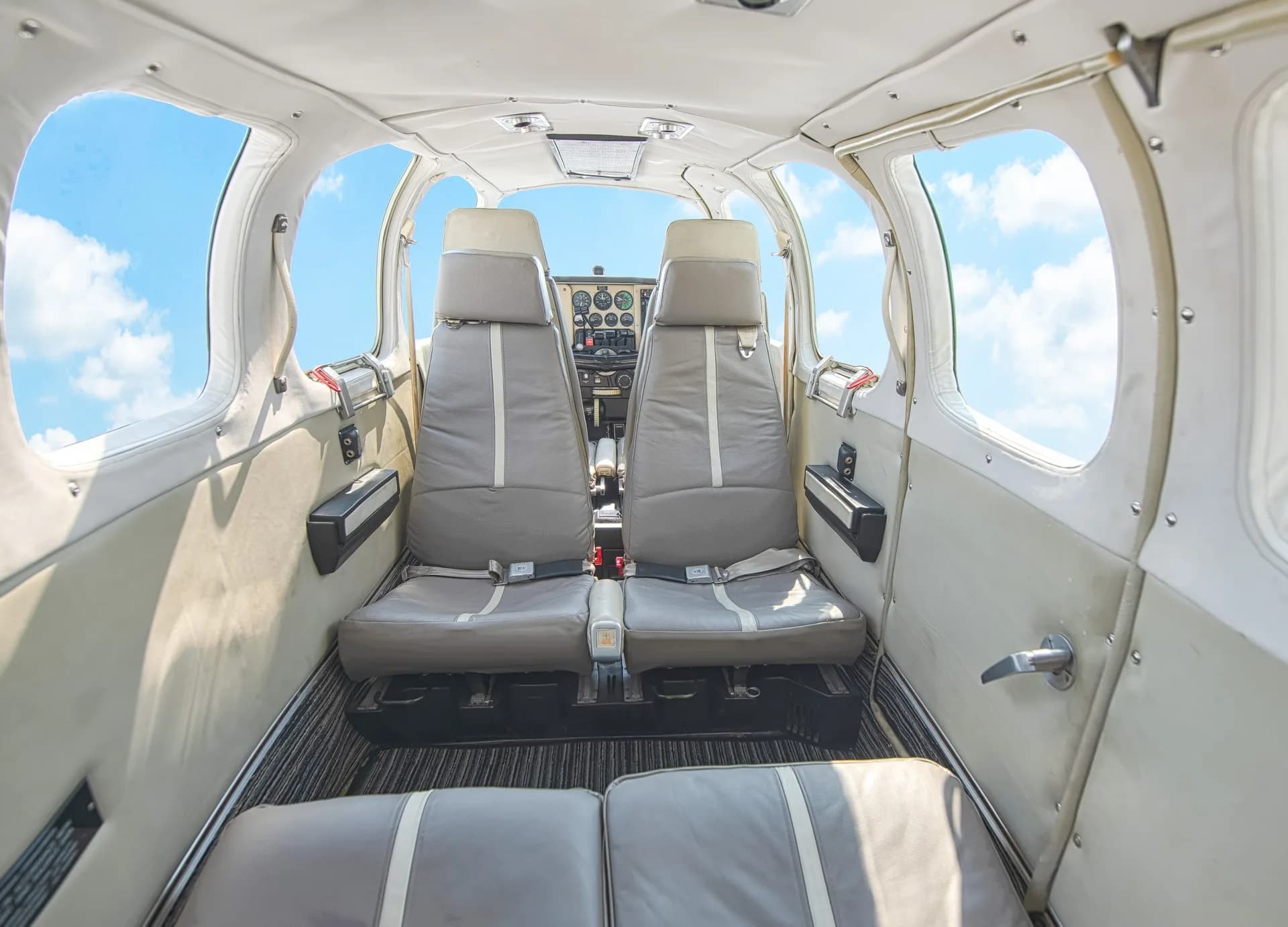 Forward view of the Beechcraft Bonanza cabin showing seats and instrument panel.