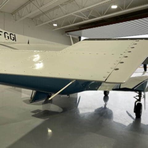 Close-up of the wing and tail of a Piper PA-31 Navajo with the registration C-FGGI.