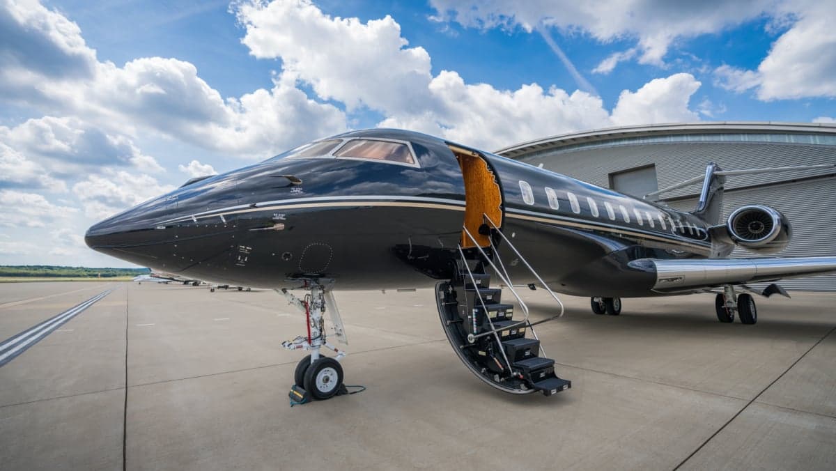 Close up of a black and silver jet with the stairs down.