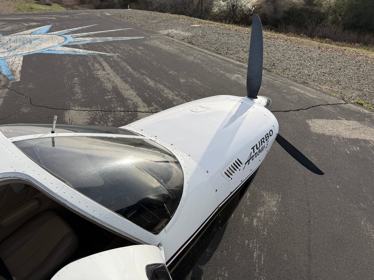 Top view of the Turbo Arrow III aircraft on the runway.