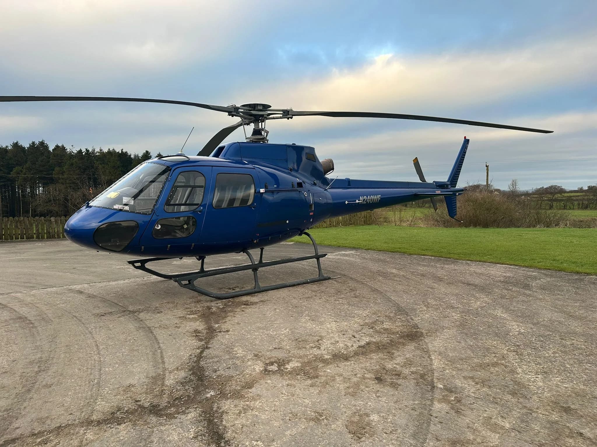 N240WF helicopter parked on the ground.