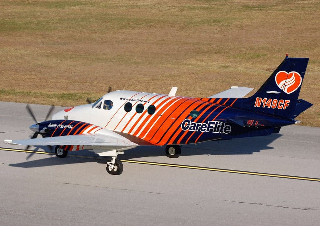 A Beechcraft King Air C90A aircraft with a distinctive CareFlite livery on the tarmac.