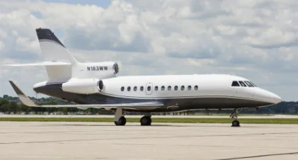 A white and gray aircraft with registration N183WW is parked on the tarmac.
