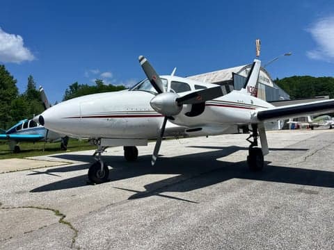 A white and maroon twin-engine aircraft, N30DF, parked on the tarmac.