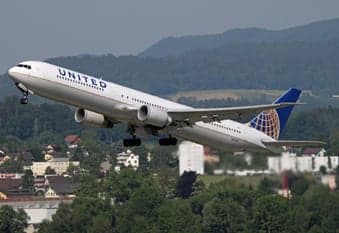 A Delta Boeing 767 in pink ribbon livery on approach.