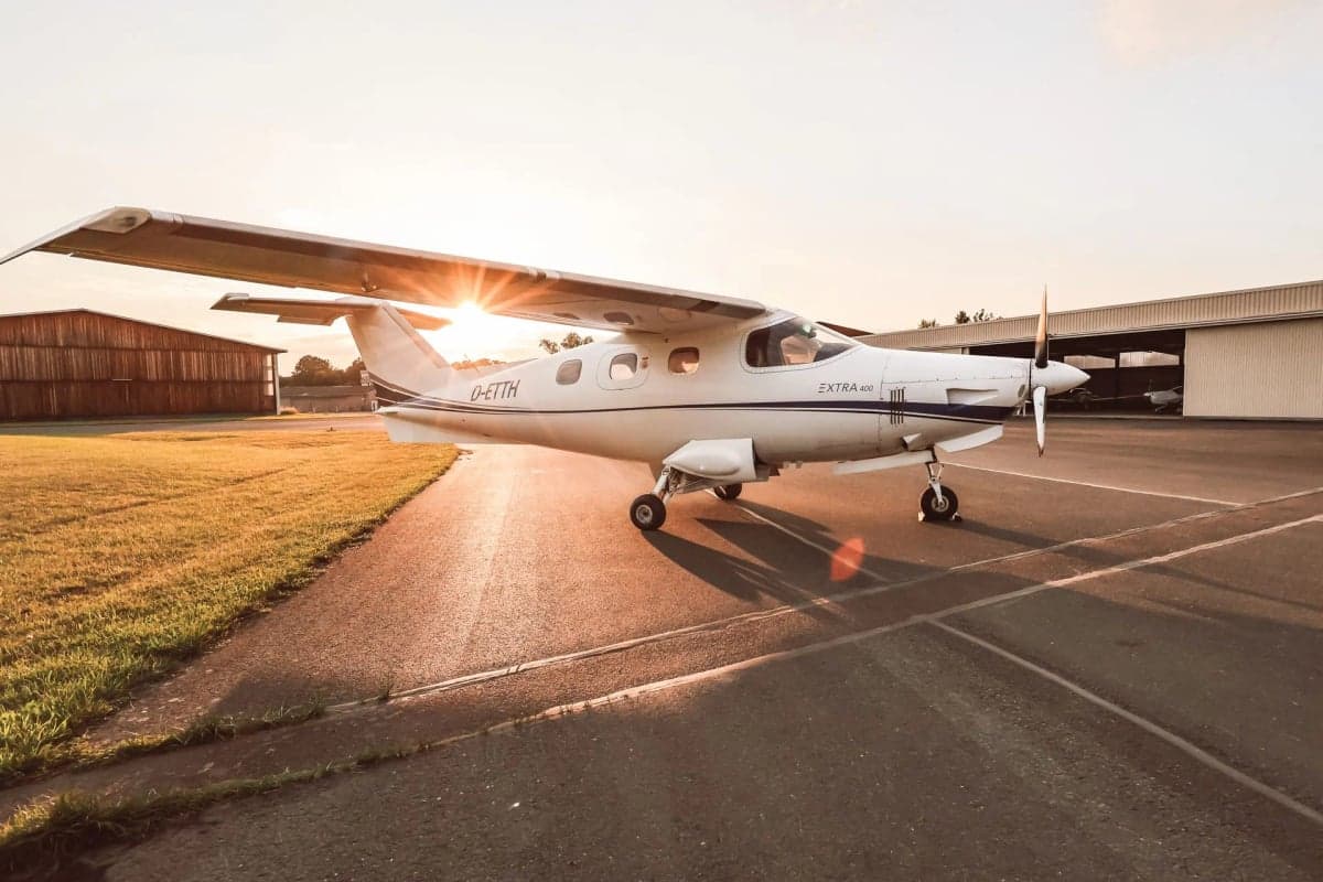 Extra 400 aircraft D-ETTH parked on the tarmac at sunset.