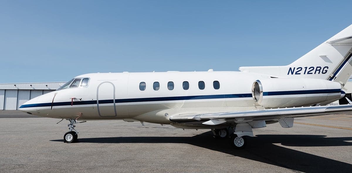 Side view of the aircraft N212RG on the tarmac.