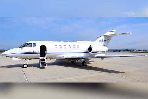 A white jet aircraft with blue stripes and the tail number N45GD is parked on the tarmac.