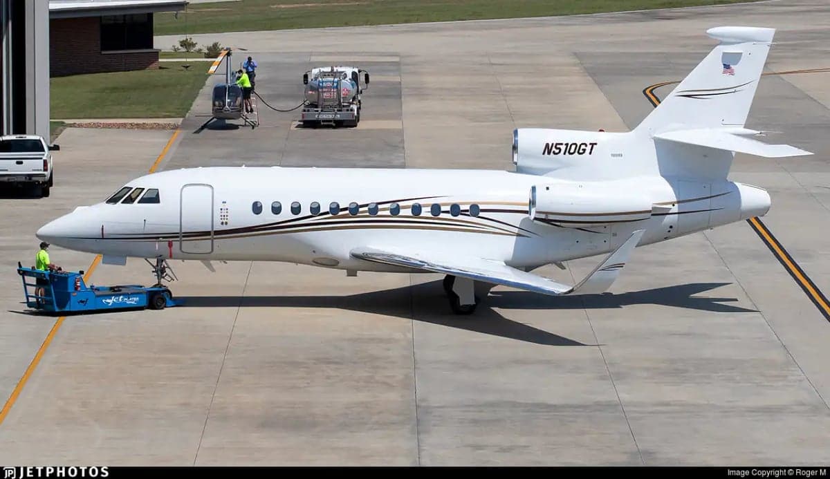 A white Falcon 7X aircraft with registration N510GT is parked on the tarmac.