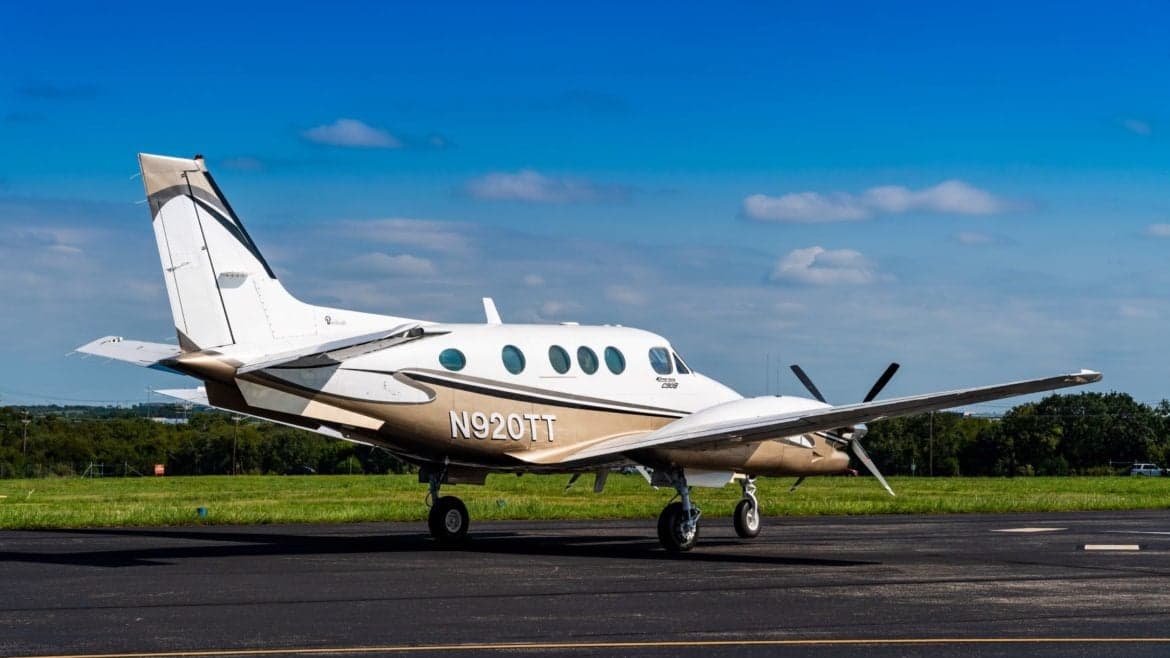 A King Air C90GTi aircraft with registration N920TT is parked on the tarmac.
