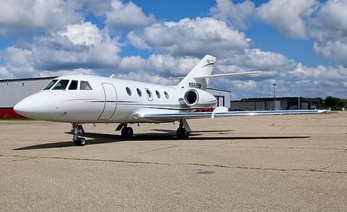 A Hawker jet with registration N998BM parked on the tarmac.