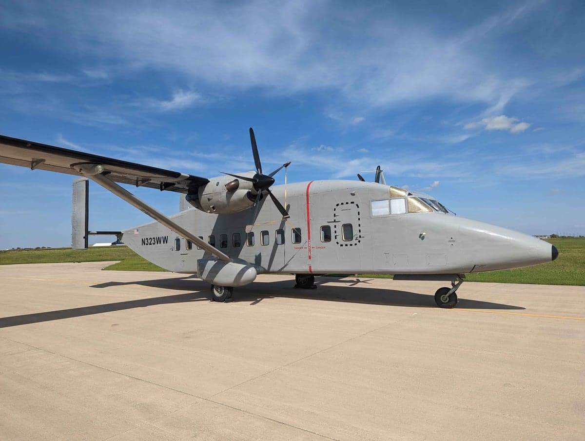 Side view of a gray Short Skyvan aircraft on the tarmac.