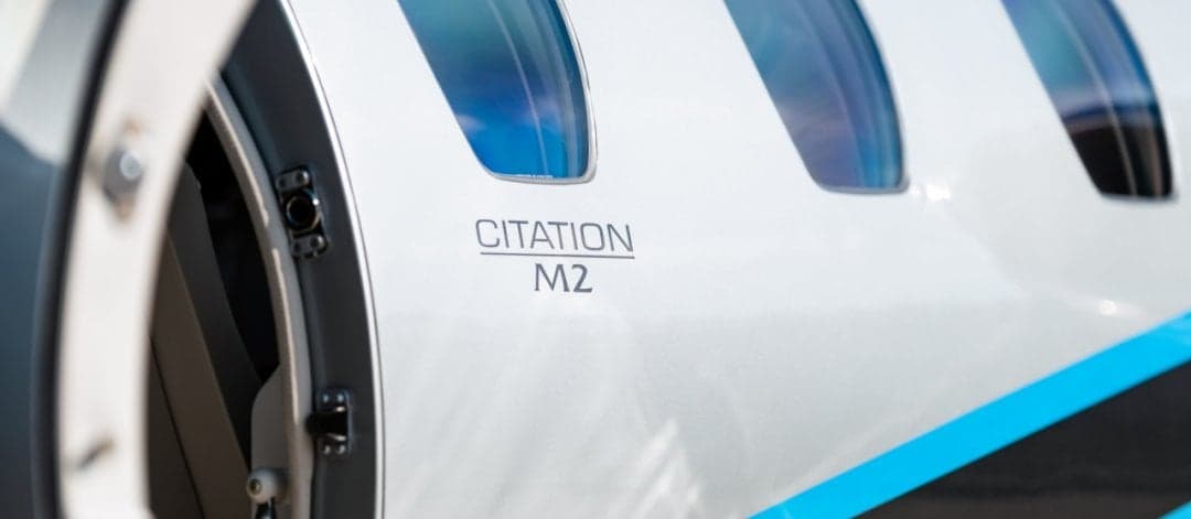 Close-up of the Citation M2 logo on the side of the aircraft.