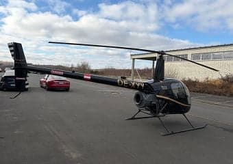 Robinson R44 helicopter OE-XYY parked on the tarmac.