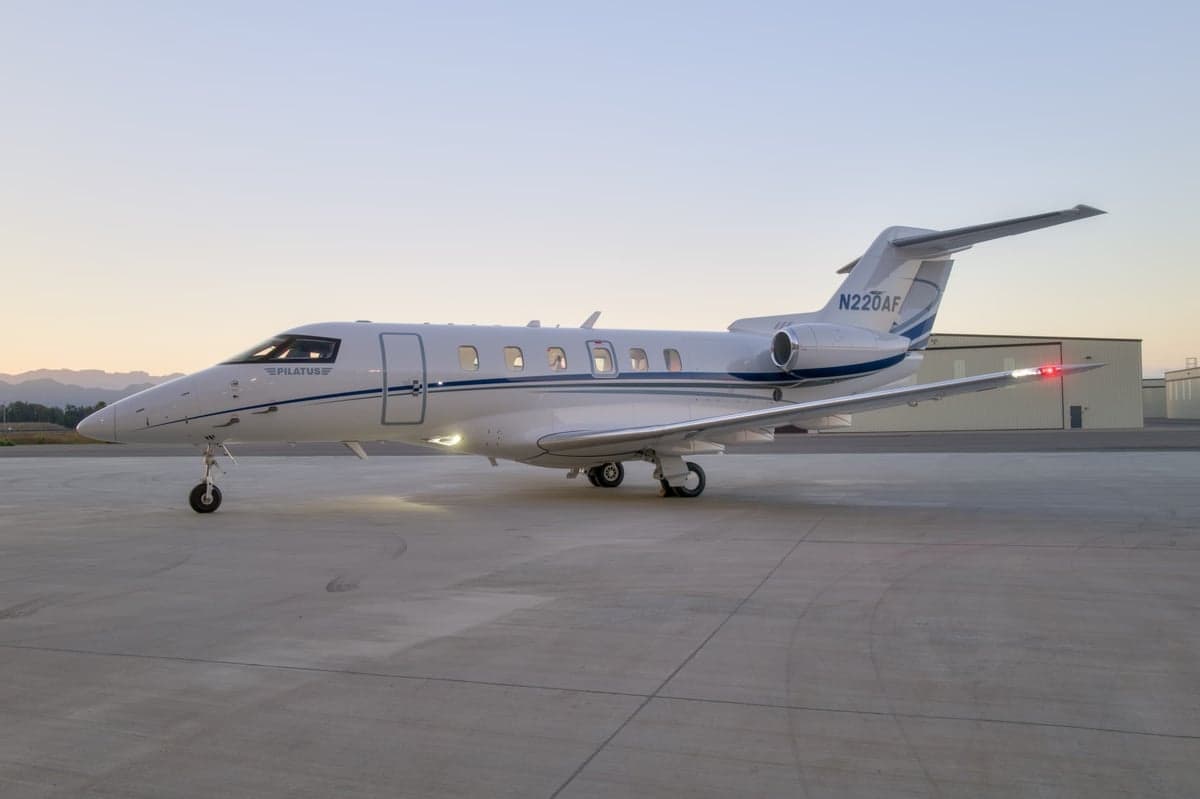 Pilatus PC-24, registration N220AF, parked on the tarmac at dusk.