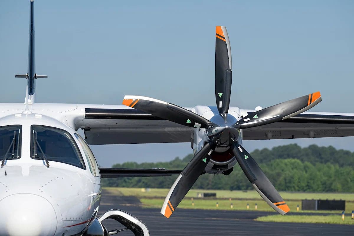 Close up of the propeller and nose of the N33EW aircraft on the tarmac.