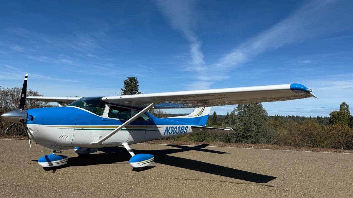 N303BS, a blue and white Cessna, parked on the tarmac.