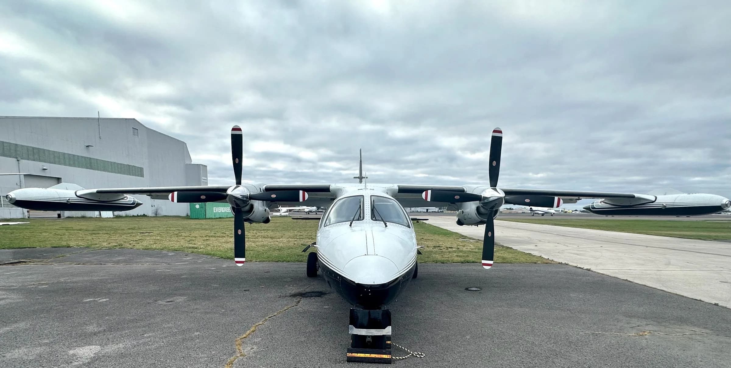 Front view of a white and black Shorts Skyvan aircraft on the tarmac.